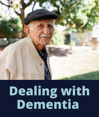 Older man with a mustache wearing a hat staring at the camera.